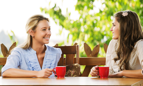 Two friends talking gossip to each other